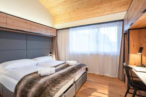 Postel nebo postele na pokoji v ubytování SWISSPEAK Resorts Thyon 4 Vallées