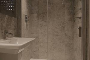 a bathroom with a sink and a shower at North Laine Townhouse with Jacuzzi Hot Tub in Brighton & Hove +17 photos