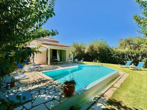 a swimming pool in the yard of a house at Beach Villa Fotini with private pool by DadoVillas in Lefkada Town