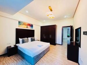 Un dormitorio con una cama grande en una habitación. en Aspire Tower -Two Bedroom Urban Getaway, en Manama 32 fotos más