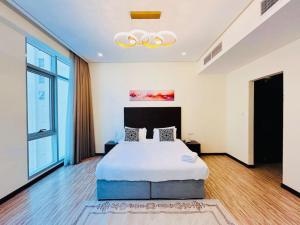 a bedroom with a large bed and a chandelier at Aspire Tower - One Bedroom Sleek Suite in Manama +22 photos