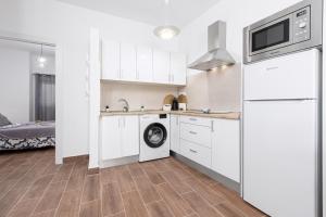 a kitchen with white cabinets and a dishwasher at Home2Book Cozy Beachfront Getaway in Tarajalejo in Tarajalejo +16 photos