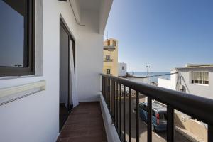a balcony with a view of a city at Home2Book Cozy Beachfront Getaway in Tarajalejo in Tarajalejo