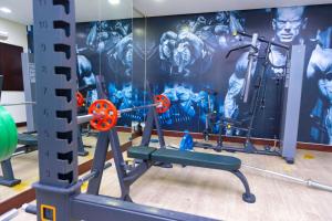 a gym with a marvel mural on the wall at Aspire Tower - Plush One Bedroom Juffair in Manama