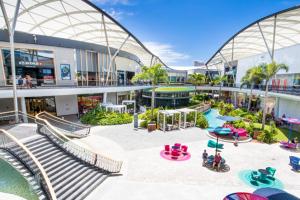 an empty shopping mall with a playground and slides at Serene Hinterland Dream from the Star - 1BD Luxe Apartment on The Star Casino in Gold Coast