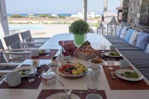 un tavolo con sopra dei piatti di cibo di Galani, Immaculate Home with Private Pool & Beach View in Kastraki, Naxos a Kastraki