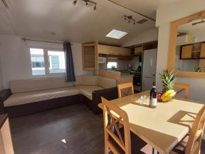 a living room with a dining table and a couch at Camping Tucan - Mobile Homes by Lifestyle Holidays in Lloret de Mar