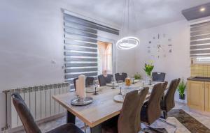a dining room with a long table and chairs at Lovely Home In Dugopolje in Dugopolje