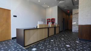 an office lobby with a reception desk and red machines at DoubleTree by Hilton Long Island City, NY in Long Island City