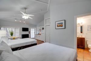 a bedroom with two beds and a ceiling fan at Ibis Suite - Southernmost Sanctuary in Key West