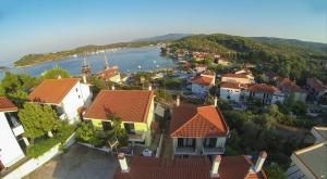 an aerial view of a town with a river and houses at Dasea Houses in Ormos Panagias