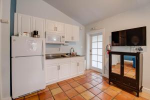 a kitchen with white cabinets and a white refrigerator at Osprey Suite - Southernmost Sanctuary in Key West