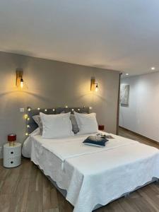 a bedroom with a large bed with white sheets and pillows at Location à Porto Vecchio in Porto-Vecchio +44 photos