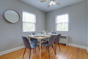 a dining room with a table and chairs and a mirror at Prime Alexandria Location Corporate Apt in Alexandria