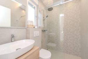 a bathroom with a white sink and a shower at Villa Nova Excellence 2, villa with private pool in Novalja