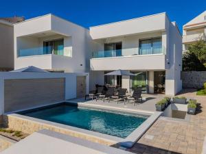 a house with a swimming pool in front of it at Villa Nova Excellence 2, villa with private pool in Novalja +78 photos