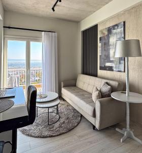 a living room with a couch and a table at Frederica Luxury Apartments in Lagyná