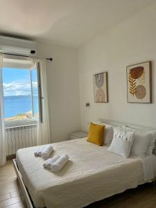 a bedroom with a large bed with two towels on it at Il Sogno del Lago in Anguillara Sabazia