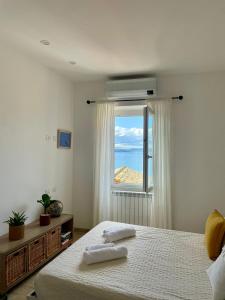 a bedroom with a bed and a window at Il Sogno del Lago in Anguillara Sabazia +36 photos