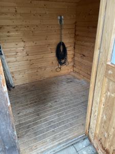 an inside of a wooden sauna with a hanger at meywohnen Bad Endorf in Bad Endorf