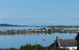 a view of a large body of water with houses at Aultbea Lodges in Aultbea