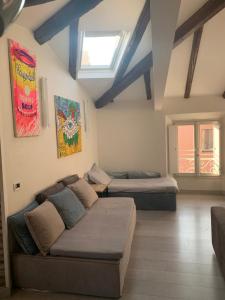 a living room with two beds and a couch at Mansarda Teatro Duse Centro in Bologna