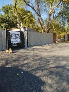 a cat laying on the ground next to a fence at 26 molen street in Rustenburg