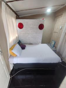a bed in a small room with two red lights at 26 molen street in Rustenburg