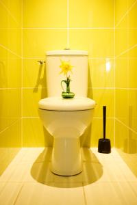 a yellow bathroom with a toilet with a flower on it at bel appartement tout juste rénové in Vierzon +4 photos