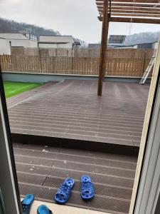 two pairs of blue flip flops sitting on a balcony at Kong's heyri pet-friendly in Paju