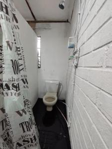 a small bathroom with a toilet in a brick wall at 26 molen street in Rustenburg