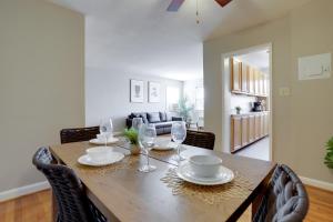 a dining room with a wooden table and chairs at Stylish Corporate Apartment in Alexandria in Alexandria