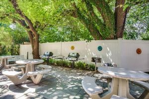 a group of picnic tables and chairs next to a fence at Stylish Corporate Apartment in Alexandria in Alexandria
