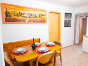 a dining room with a wooden table and chairs at Golden River in Unterseen