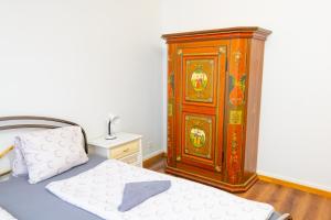 a bedroom with a bed and a wooden cabinet at Golden River in Unterseen