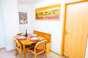 a dining room with a table and chairs and a door at Golden River in Unterseen