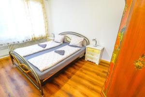 a small bedroom with a bed and a night stand at Golden River in Unterseen