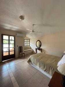 a bedroom with a bed and a window at Casa Don Pedro in Apozol
