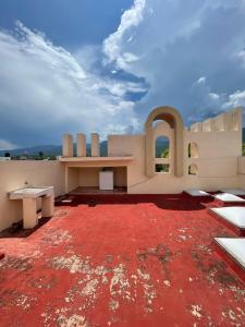 a building with a red floor and a bench on top at Casa Don Pedro in Apozol