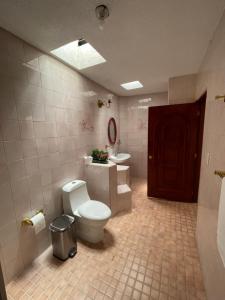a bathroom with a toilet and a sink at Casa Don Pedro in Apozol