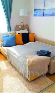 a large bed with colorful pillows in a bedroom at Feel Home DeLuxe CORVIN # FREE PARKING # AC # Elevator in Budapest