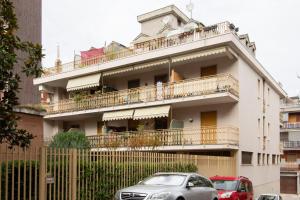 a building with a balcony with cars parked in front of it at Green Stay Bresso - due passi dal Niguarda in Bresso +21 photos