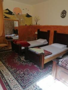 a room with two beds and a mirror and a rug at Dana Star lodge in Dana +14 photos