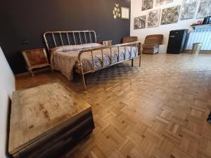 a bedroom with a bed and a wooden floor at B&B La Fenice sul Lago in Villongo SantʼAlessandro +69 photos