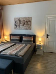 a bedroom with a large bed with two lamps at Fewo-Liza in Wernigerode