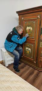 a man is drilling into a wooden cabinet at Golden River in Unterseen
