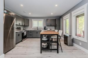 a kitchen with stainless steel appliances and a counter at Cozy Retreat W Hot Tub Bruce Peninsula in Stokes Bay