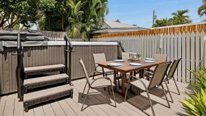 a wooden table and chairs on a deck at Duke of Catherine by Last Key Realty in Key West