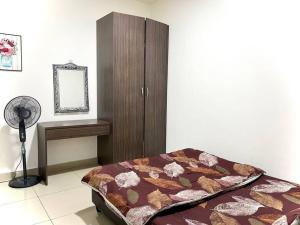 a bedroom with a bed and a cabinet and a fan at Ammara Homestay 3 Palas horizon Kea Farm in Cameron Highlands +17 photos
