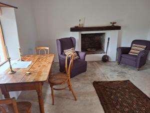 a living room with a table and chairs and a fireplace at Wild Rescue Nature Reserve in Riversdale